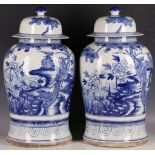 A pair of Chinese blue and white baluster vases and covers, each decorated with a pair of phoenixes,