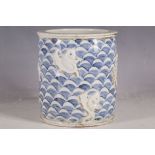 A Chinese brush pot, blue wave decoration with applied five toe, open mouth dragon, chasing