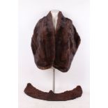 A vintage dark brown, long mink stole, satin lined, with shaped neck line, with a large brown