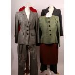 Four vintage Yves St Laurent and Saint Laurent outfits, including a hounds tooth check trouser suit,