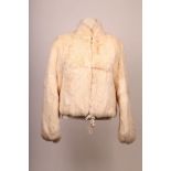 A 1960s white rabbit fur bomber jacket, with small collar, big zip up detail, long sleeve with