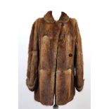 A vintage auburn and brown toned, three quarter length fur coat, with collar, cross over fastening