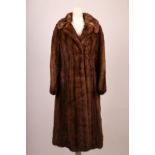A 1970s soft brown, mink full length fur coat, with collar, soft mink belt, side pockets, satin