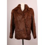 A 1980s brown fur jacket by Posh, Paris, with collar, long sleeves, side pockets, polyester