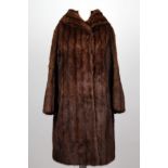 A vintage dark auburn musquash ladies fur coat, with sweeping collar, swing back, satin lined,