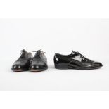 Two pairs of men's shoes, including a pair of black brogues, with leather soles, with a pair of
