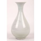 A very pale Chinese celadon pear-shaped vase. Qing, Daoguang mark and possibly of the period. 19cm