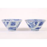 A pair of Chinese conical blue and white cups. Kangxi, 18th Century. The exterior painted with