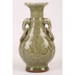 A Chinese celadon crackle glazed vase with ring hang. Ming Dynasty or later. Of pear-shaped form