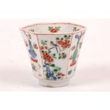 A Chinese famille verte hexagonal section cup. Qing, Kangxi. The sides decorated alternately with