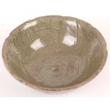 A crackle-glazed celadon bowl with slightly foliated edges. Song Dynasty or later, 6.5cm H, 17cm