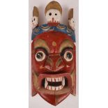 An Indian wooden kali mask, acquired in Kalekta over fifty years ago, 46cm L.