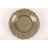 A Chinese longquan celadon glazed foliate rim dish. Ming dynasty. Thickly potted and raised on a low