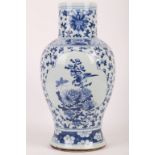 A Chinese blue and white vase. Late Qing, 19th Century. Of baluster form, with extended upright neck