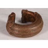 A copper African money weight bangle.