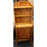 An early 19th Century satinwood waterfall bookcase, arch top with two shelves over cupboard, door