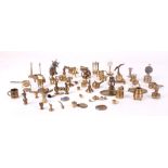 A large quantity of brass dolls house accessories, including clocks under domes, lamps, canon, pans,