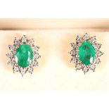 A pair of 18ct gold, emerald and diamond cluster earrings.