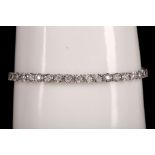 An 18ct white gold and diamond tennis bracelet, 2ct total.