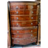 A Georgian mahogany cased bow-fronted chest on chest, having seven drawers, raised on bracket feet.