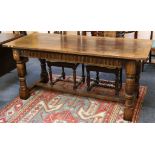 An oak dining table, with lunette frieze, raised on turned legs joined by a stretcher.