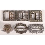 Two white metal (TAS) buckles, sold together with three paste set buckles and a filigree brooch. (6)