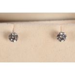 A pair of 14ct white gold and diamond stud earrings, dia 0.50pts.