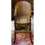 A Victorian mahogany caned child's high chair (AF: safety bar and foot rest missing).
