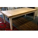 A light oak solid plank kitchen table, set on painted tapering block legs, 215 x 107cm.