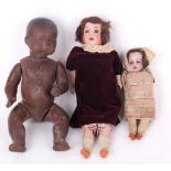 A Black Armand Marseille Dream Baby with two more dolls, German 1900s, having brown sleeping eyes,