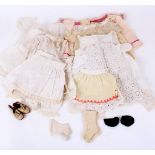 A Victorian collection of small dolls clothes from various dolls, including three dresses, white