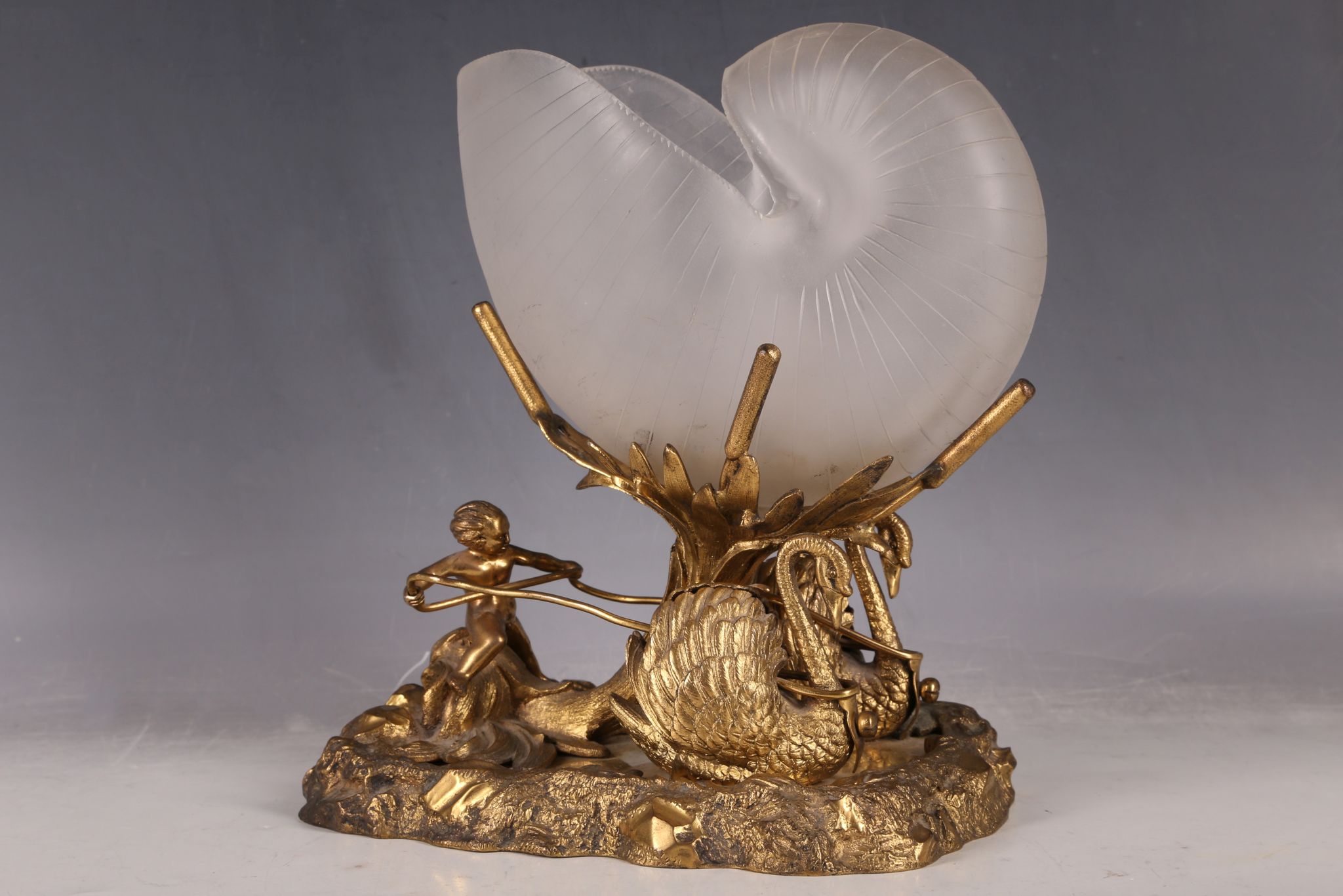 A decorative 19th Century gilt metal table ornament in Palais Royale style, modelled as a cherub and