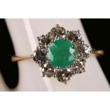 An 18ct yellow gold, emerald and diamond cluster ring (dia: approx. 1.50ct, em:1.20ct).