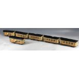 Six 1900s British 0'gauge passenger carriages, hand-painted finish with passengers at the windows,