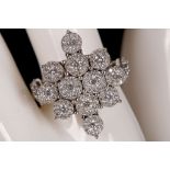 A large 18ct white gold and diamond multi cluster dress ring, 1.30ct.