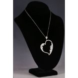 An 18ct white gold and diamond set heart pendant, suspended from a double strand chain.