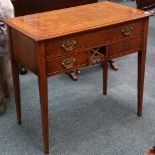A walnut writing table, with three drawers and raised on square section tapering legs.