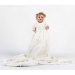 An 1900s German character baby doll, with brown sleeping eyes, open mouth, two upper teeth, mohair