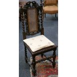 A set of four oak Jacobean style dining chairs, with carved and caned back rests and caned seats