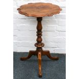 A 19th Century cartouche top walnut table, on a turned pedestal on three downswept legs, 72 x 48cm.