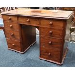 A ladies mahogany kneehole desk, nine drawers, bun handles, 109cm W.