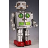 A 1960s SH, made in Japan, battery operated tin plate robot, silver colour with red feet, with