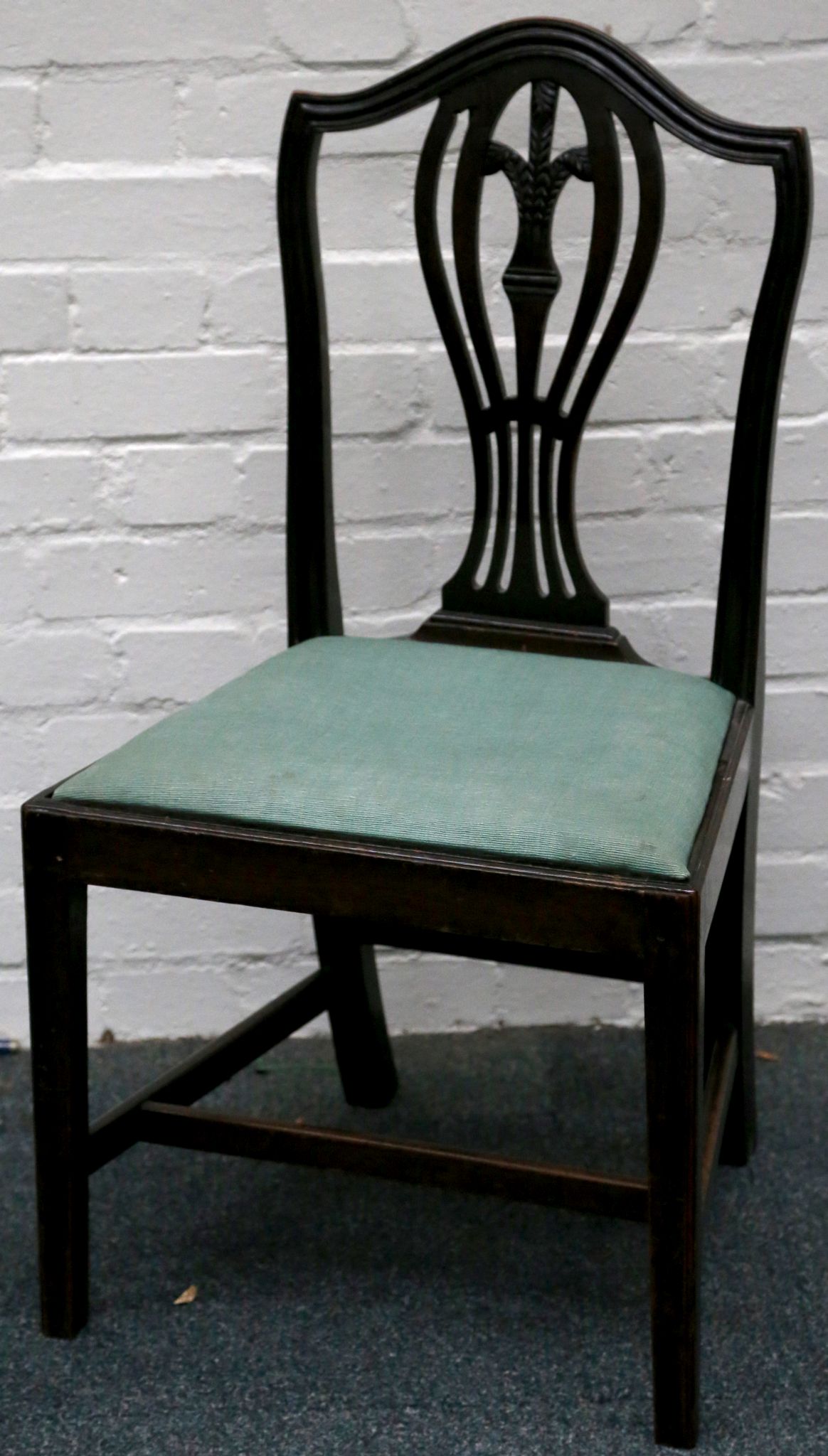 A set of six Hepplewhite style dining chairs, with wheat sheaf and pierced vase back splat, above