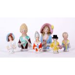 Six bisque pin cushion half dolls, five Gainsborough ladies, one wearing a top hat (largest