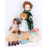 A 1960s large walking, flirty eyed Pedigree doll, home dressed in green velvet, a Rose bud,