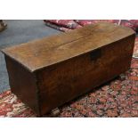 A late 17th / early 18th Century oak coffer, the hinged lid with chip carved edge, raised on block