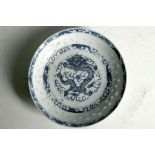 A Chinese dish, blue glaze, coiled dragon and flaming pearl to centre, leaf decoration to outer,