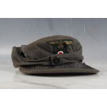 M34 3rd Reich cloth cap, field grey, single button, green and gilt cloth eagle and roundel.