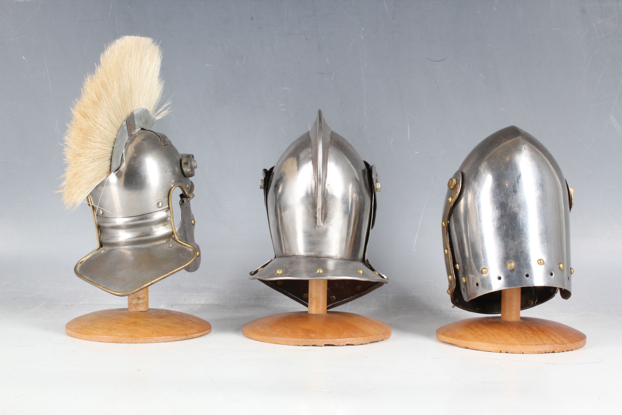 Three miniature desk top helmet ornaments; plumed Roman helmet and two knights visor helmets and - Image 2 of 2