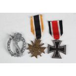 A German WW2 3rd Reich Iron Cross, 2nd class, German War Merit Cross, 2nd class, with swords, and an
